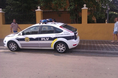 a small police car on the street of a city