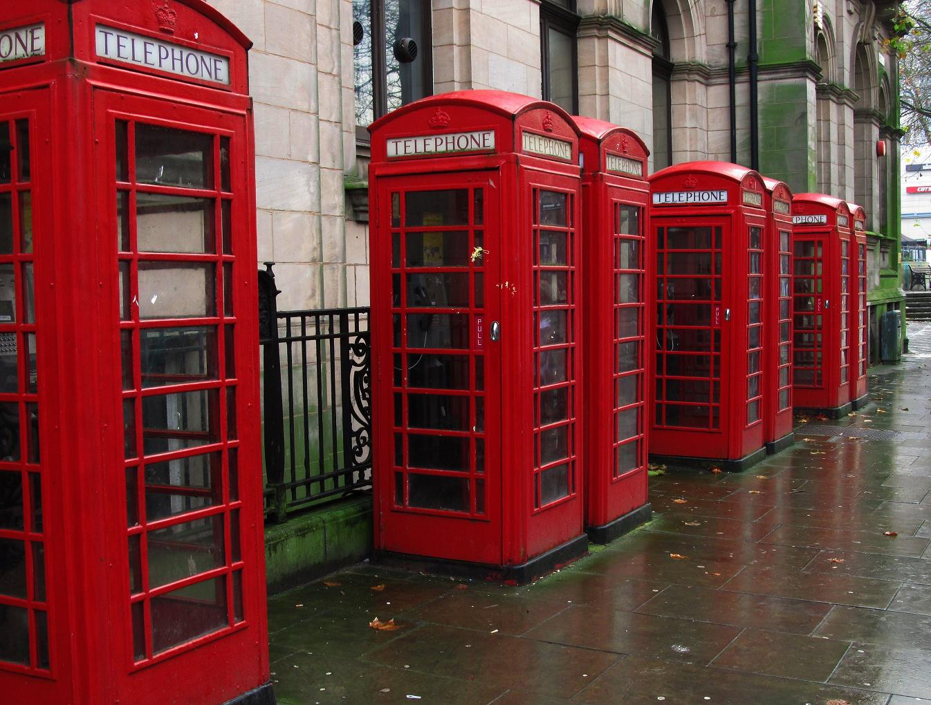 red telephone booths lined up beside each other