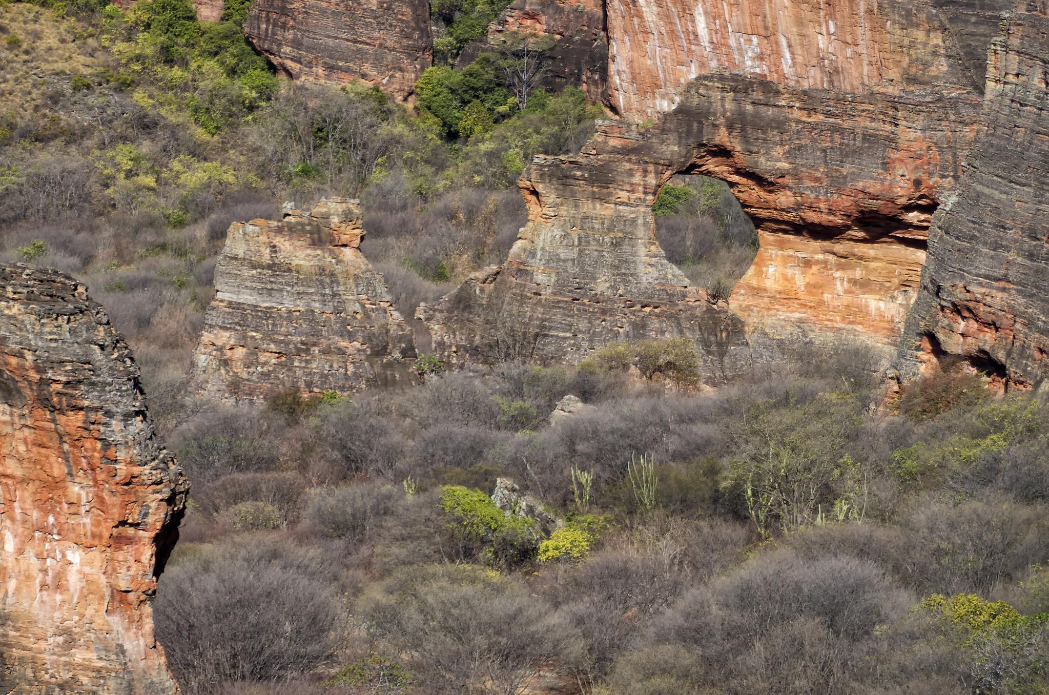 a mountain landscape is surrounded by large rock formations