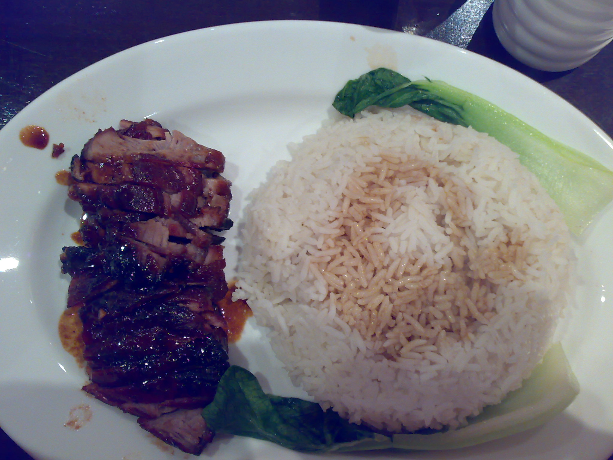 the plate is filled with rice and some meat