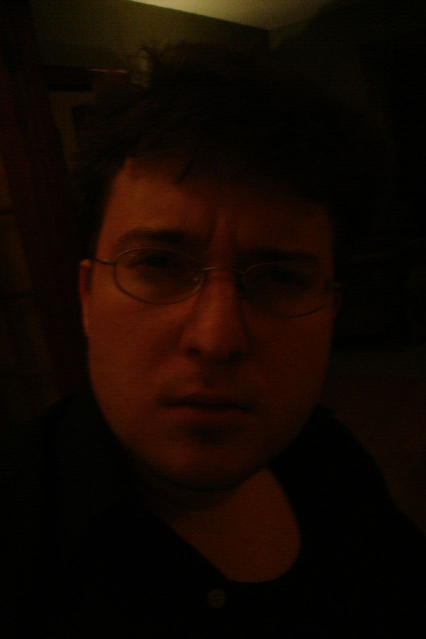 a man with dark glasses is staring at the camera