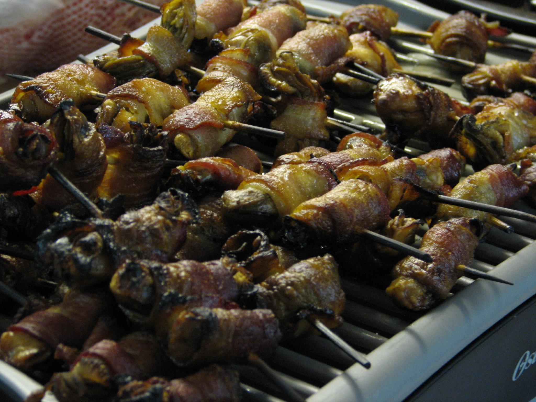 there is many skewers of food on a rack