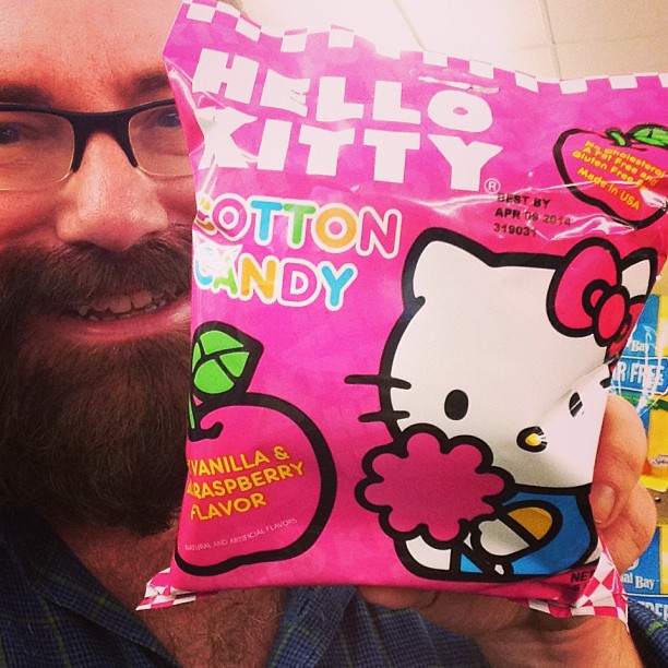 a man holding up two hello kitty cotton candy