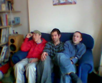 three men are sitting on the couch