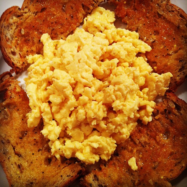 scrambled eggs and toast on top of each other