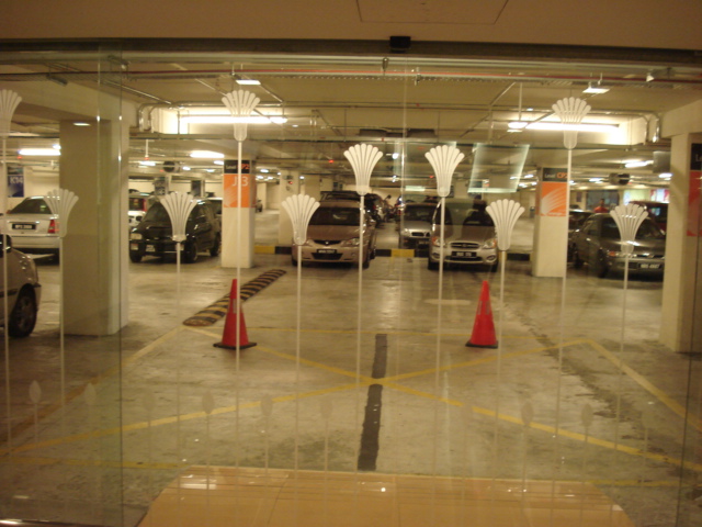 a group of cars parked in a garage next to a car park