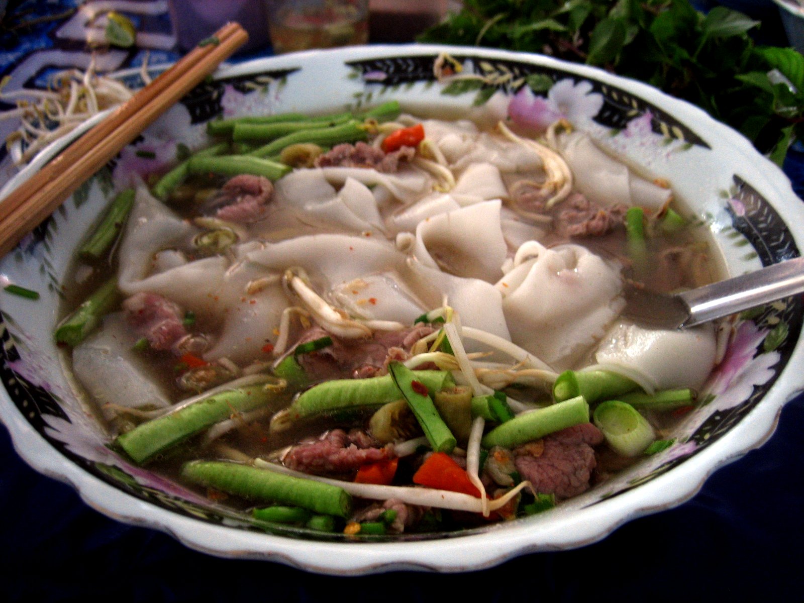 a large bowl is filled with dumplings and noodles