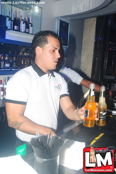a man behind the bar is pouring some drinks