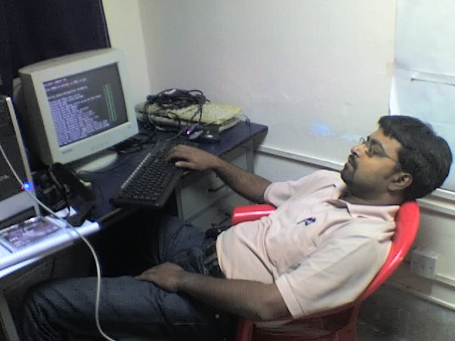 a person sits in a chair at a computer with a keyboard