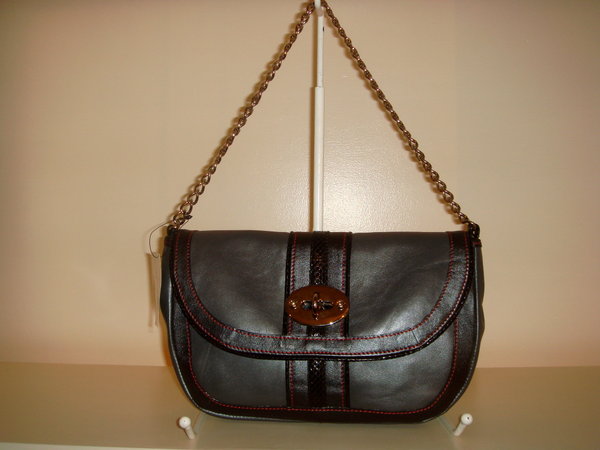 a black bag hanging on a brown chain
