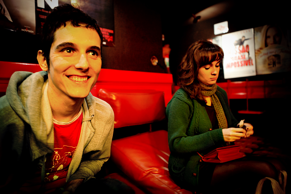 two people are sitting in a movie theater together