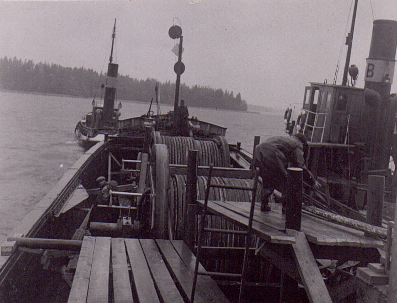 a man getting on the bow of a boat in the water