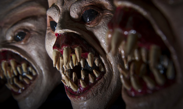 a group of three scary looking masks with mouthy teeth