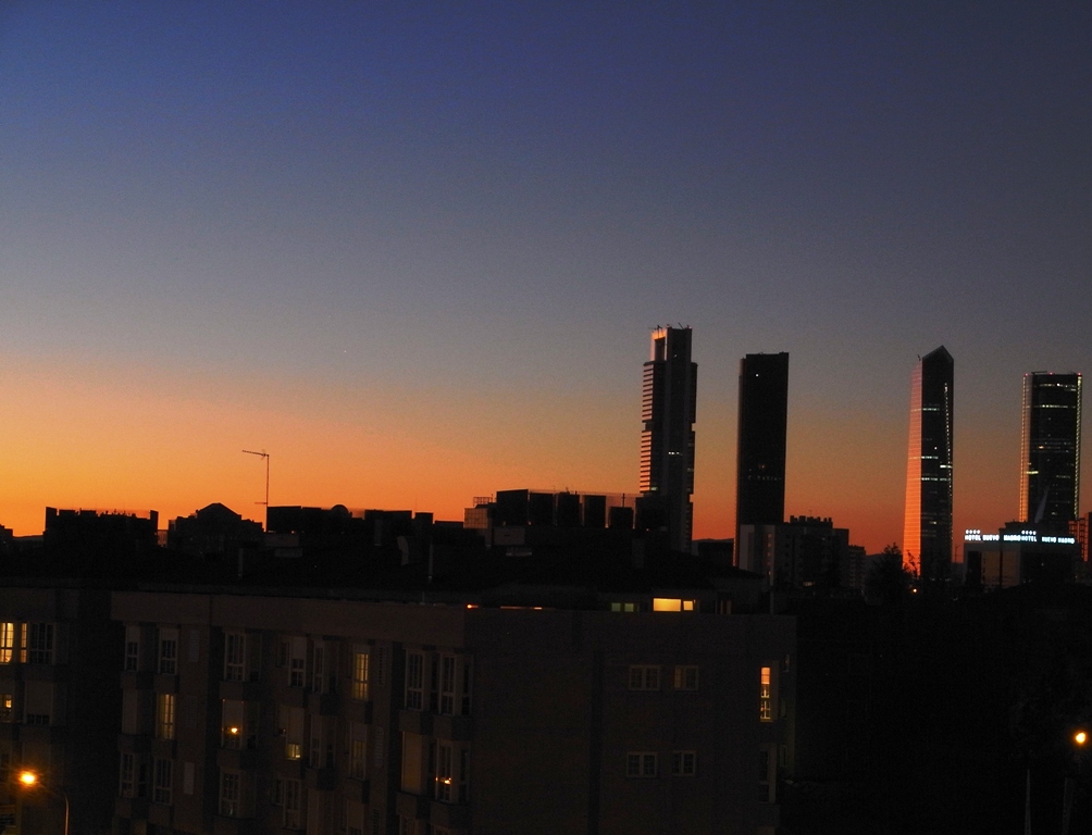 the skyline in a city at sunset with tall buildings