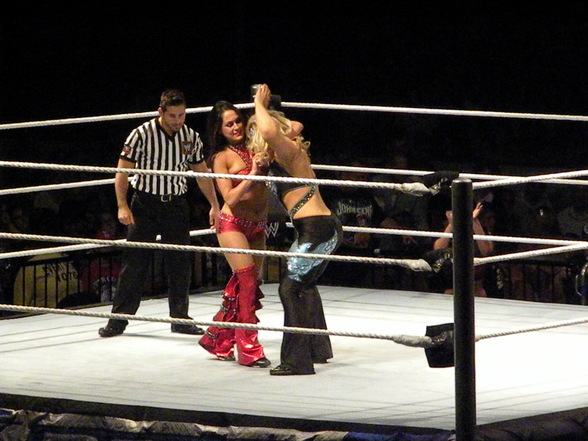 two women wrestling in a boxing ring