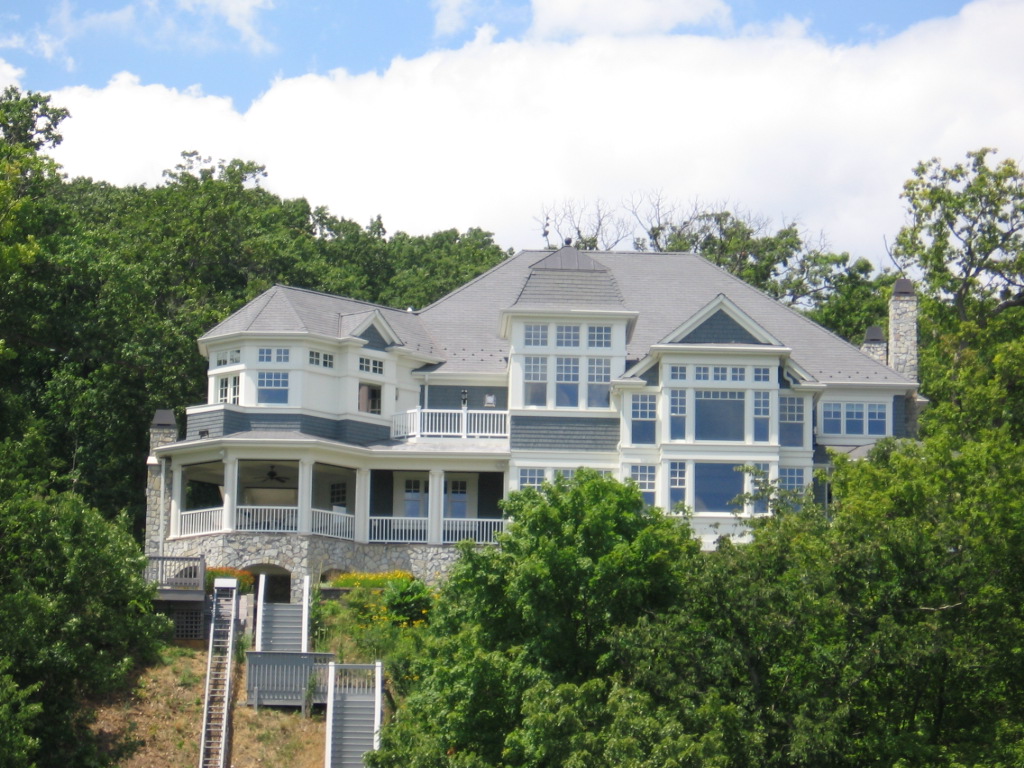 a large white house that is by the water