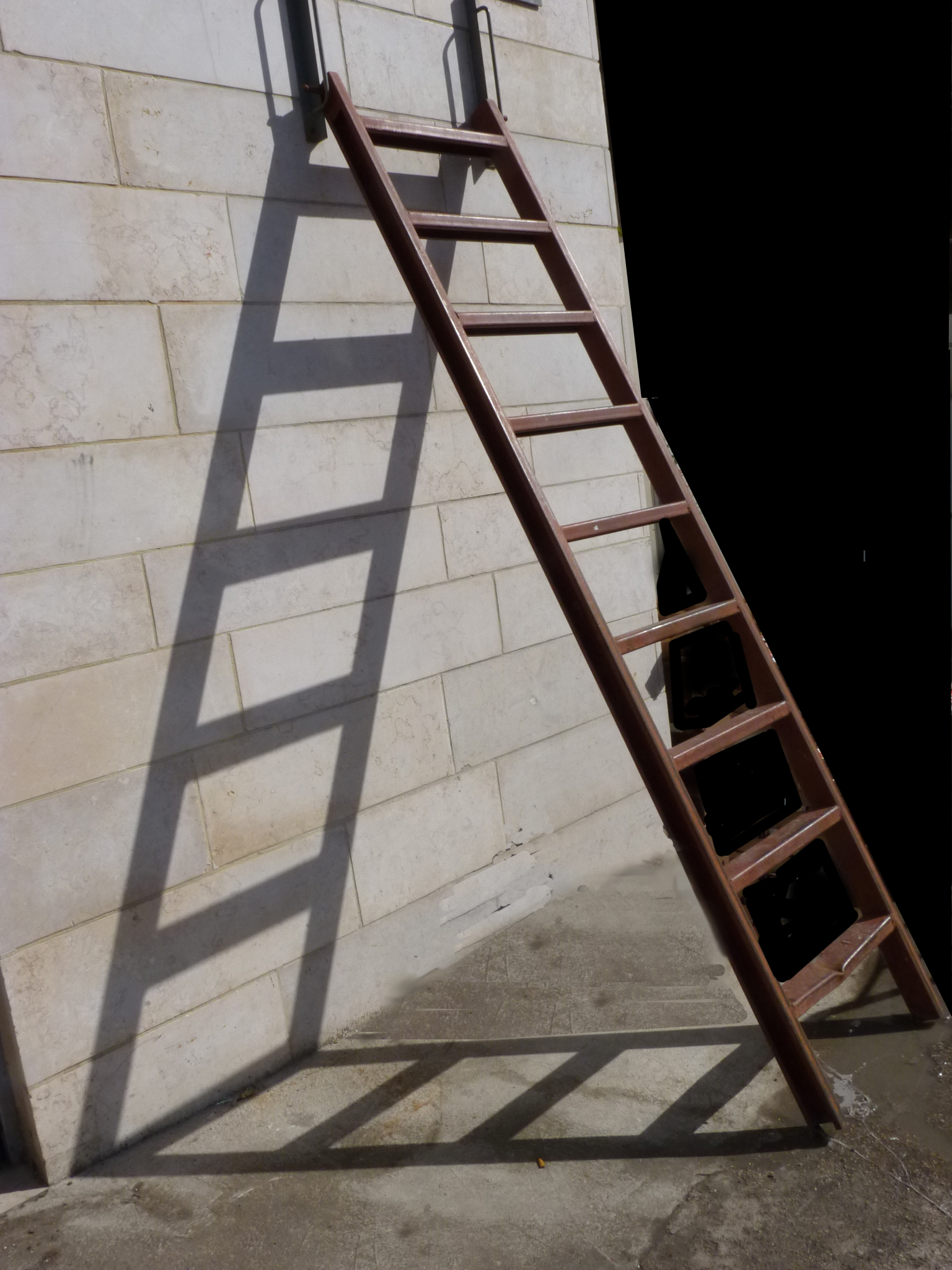 a ladder leaning against a brick wall