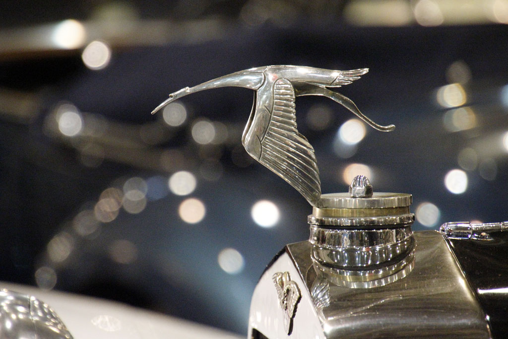 a bird statue with an elaborate top is next to some keys