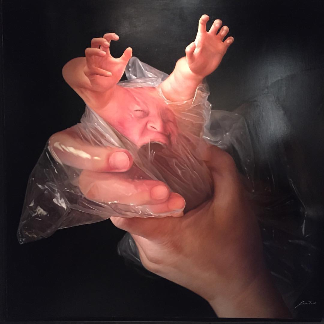 a plastic figure of a hand is holding a plastic bag