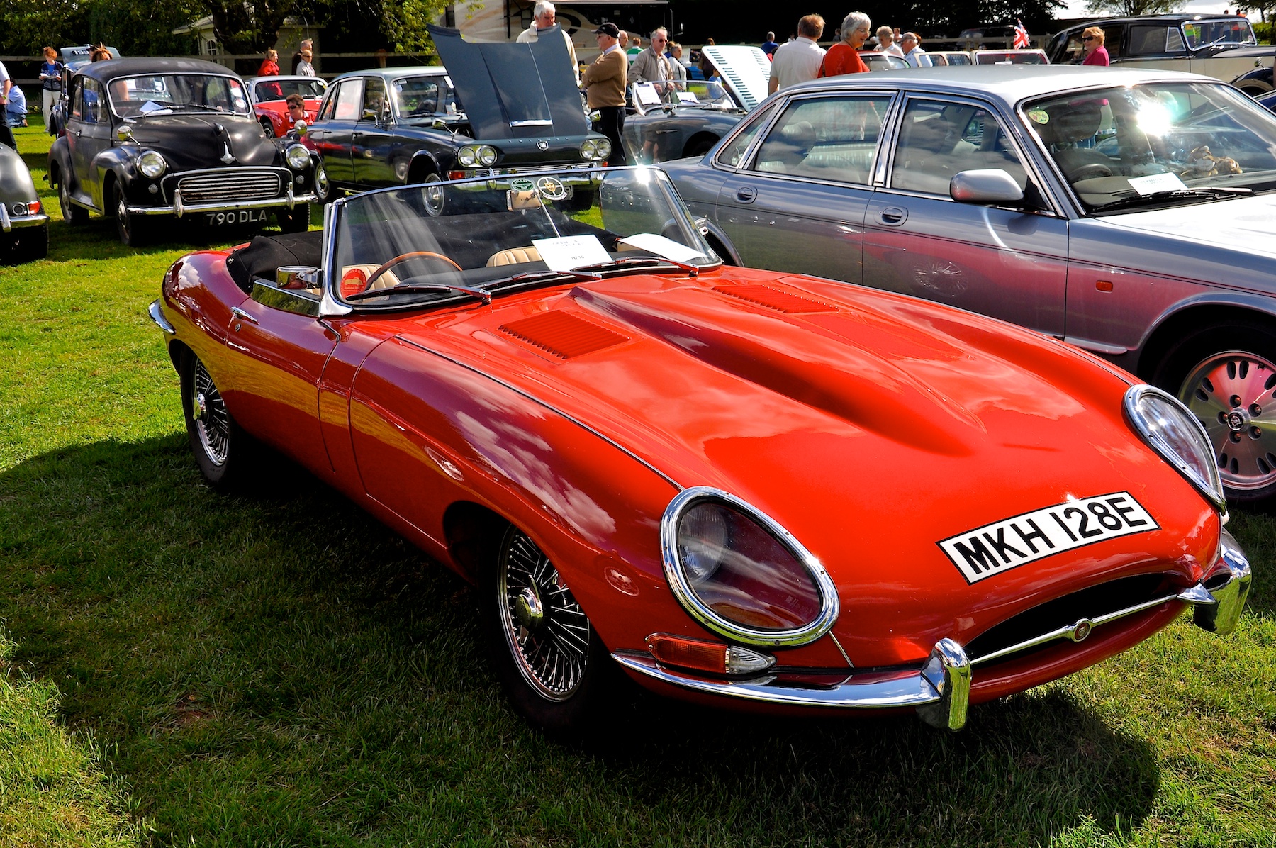 classic cars are parked in a row at a car show