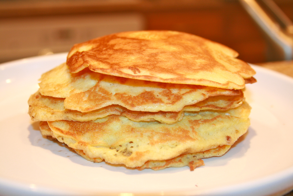 stack of pancakes on a plate with a toaster