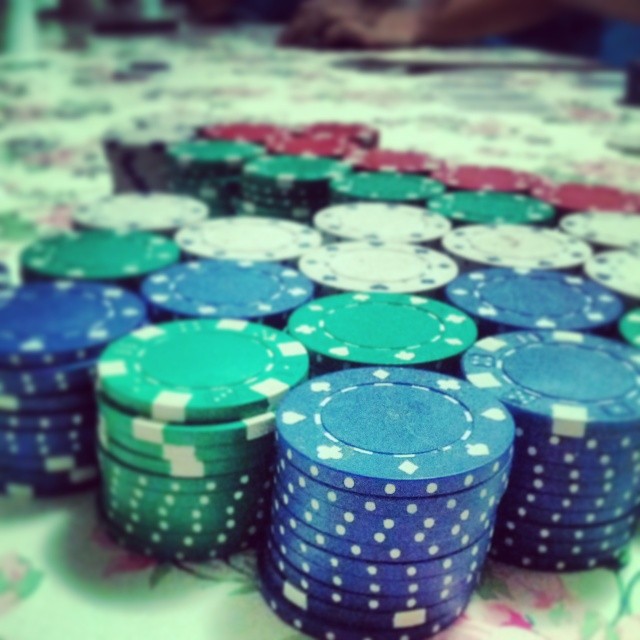 poker chips are arranged on a white table