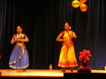 two women are performing in front of an audience