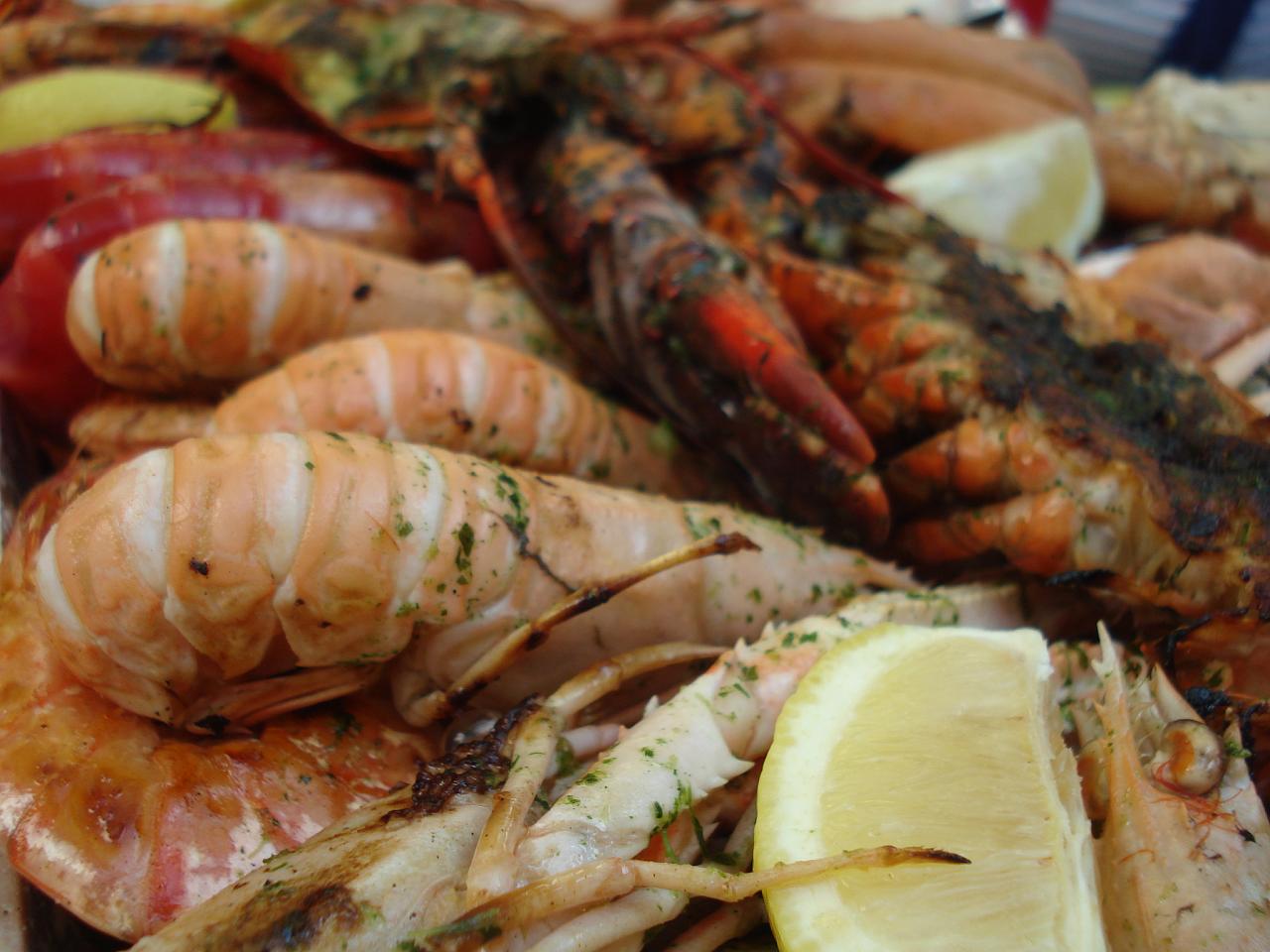 close up of shrimp, shellfish, and lemon on a table