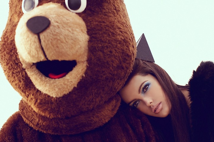 girl wearing large brown bear costume posing for a picture