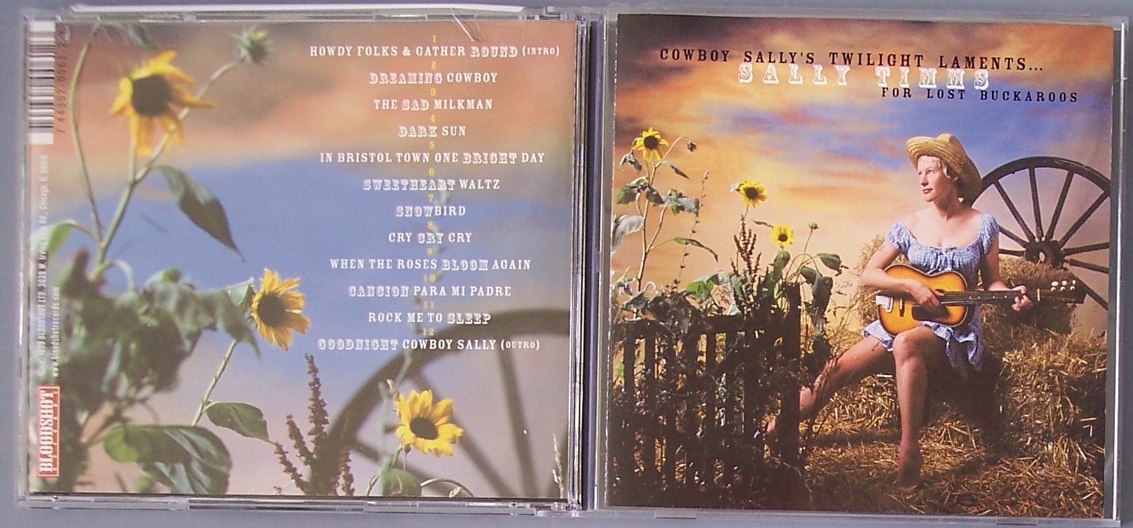 cd cover with woman sitting on a wheel surrounded by sunflowers