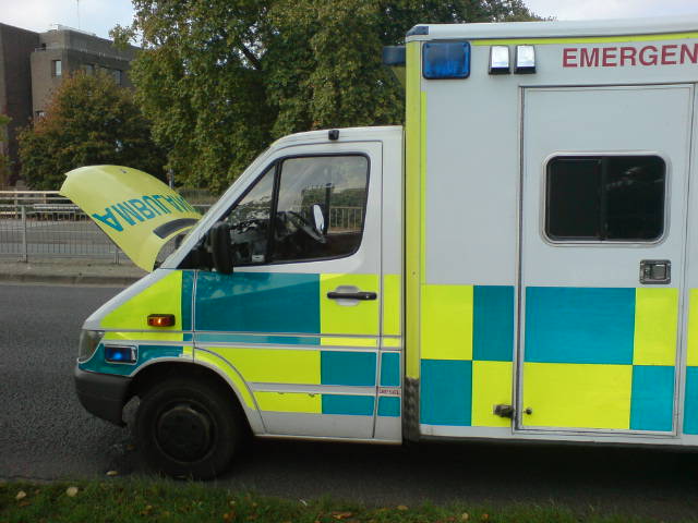 an ambulance with a man standing next to it