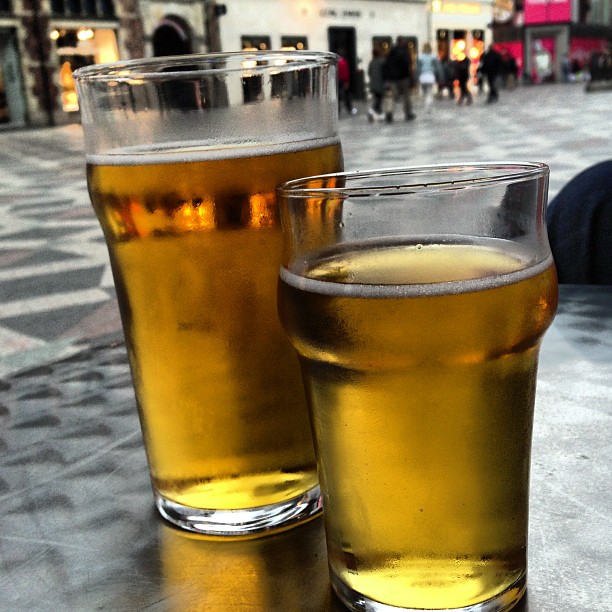 two beers on a table in a large outdoor cafe