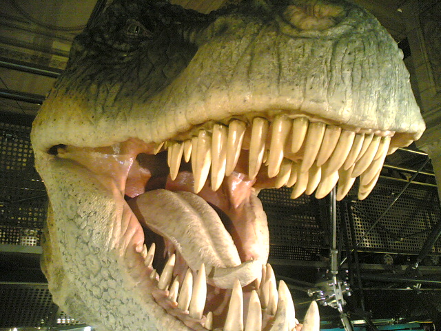 a statue of a dinosaur has sharp teeth