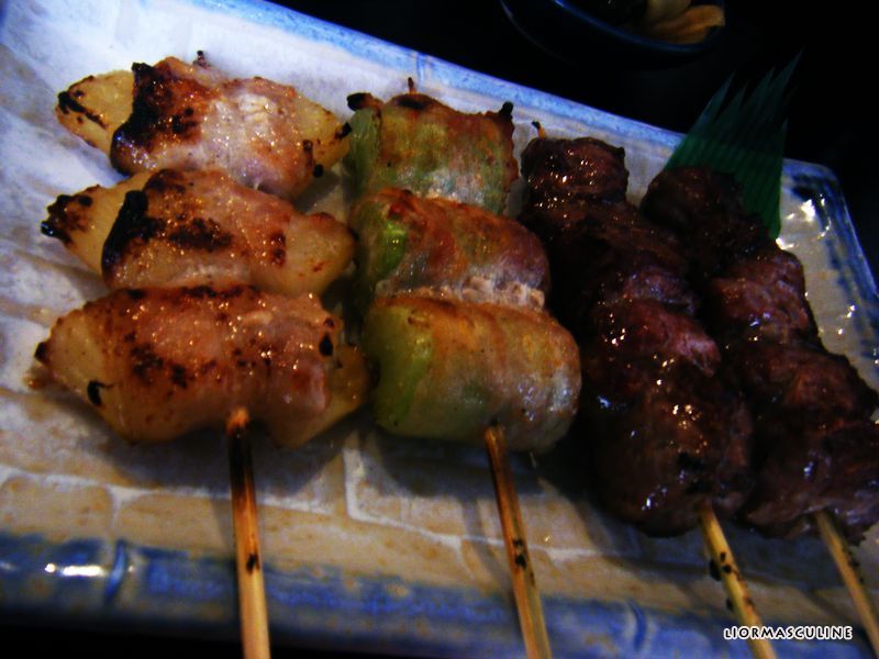 many skewered food items on a tray