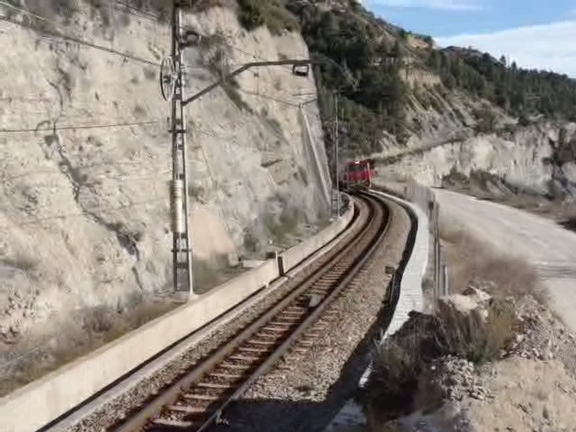 a train traveling along the side of a cliff