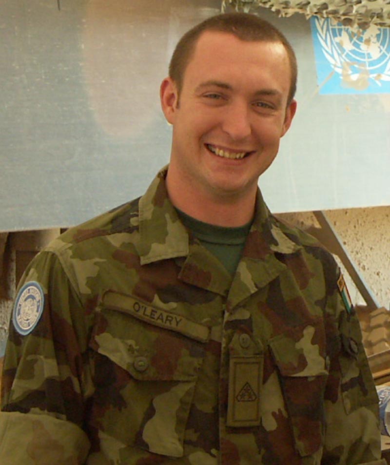 a military man smiling with a smile on his face