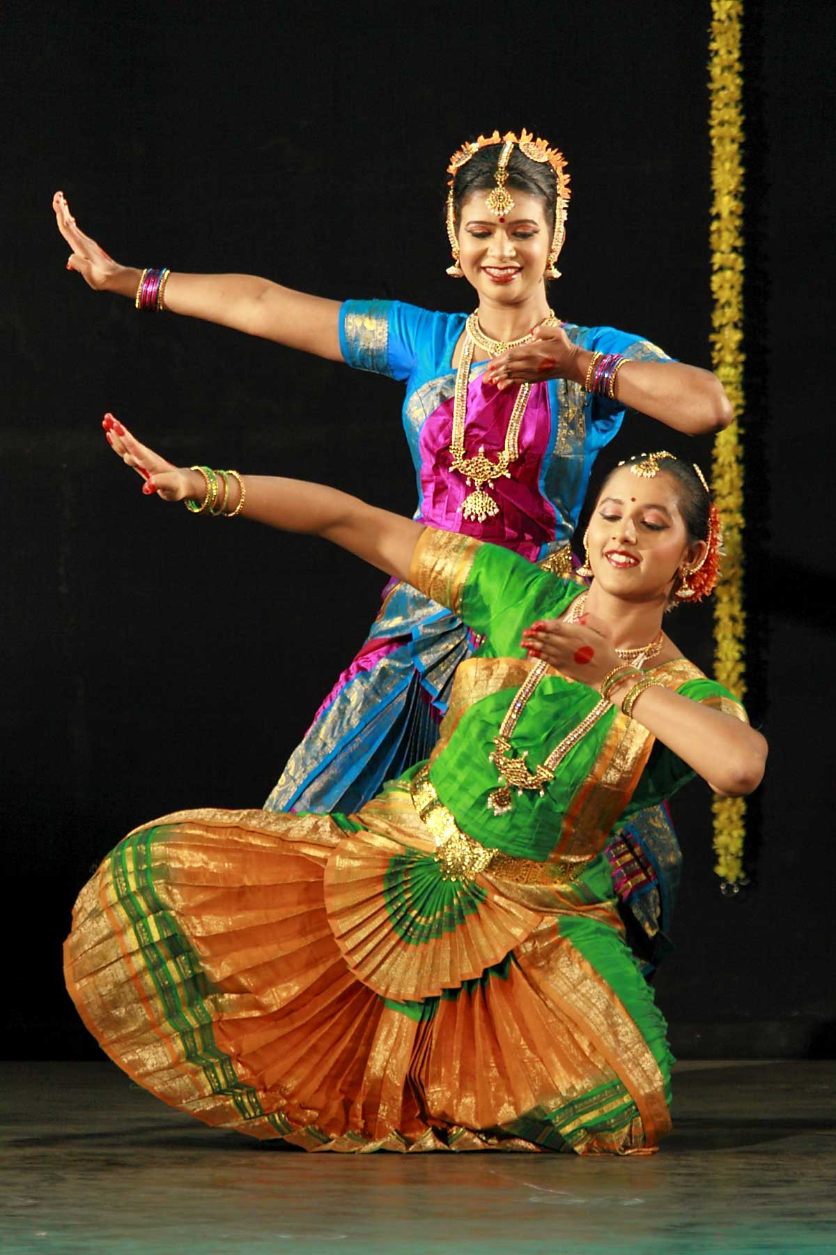 three women in indian dance costumes dancing