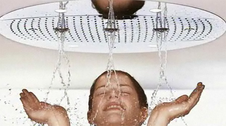 a woman is holding herself up under the shower