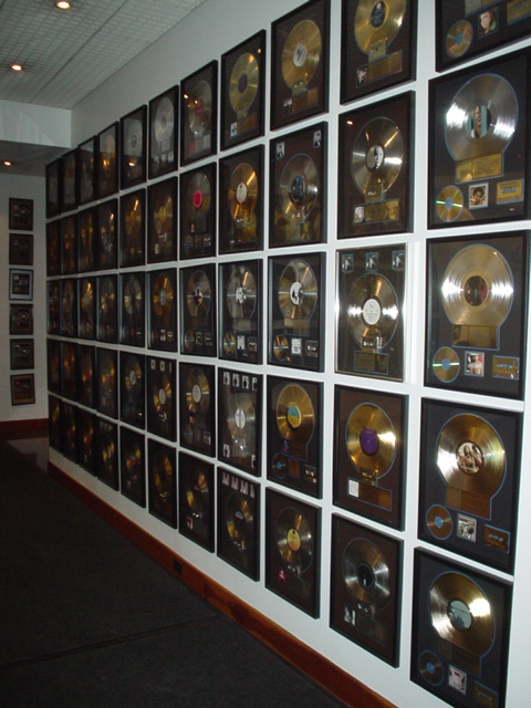lots of records sitting on the wall along with each other