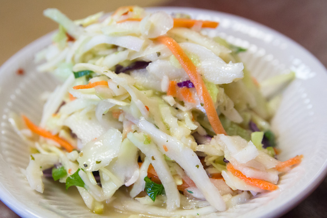 a white plate topped with salad and carrots