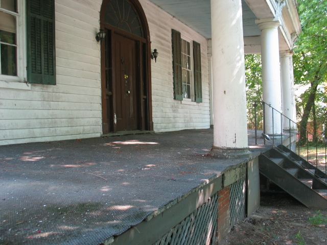 an outdoor walkway between two large porches