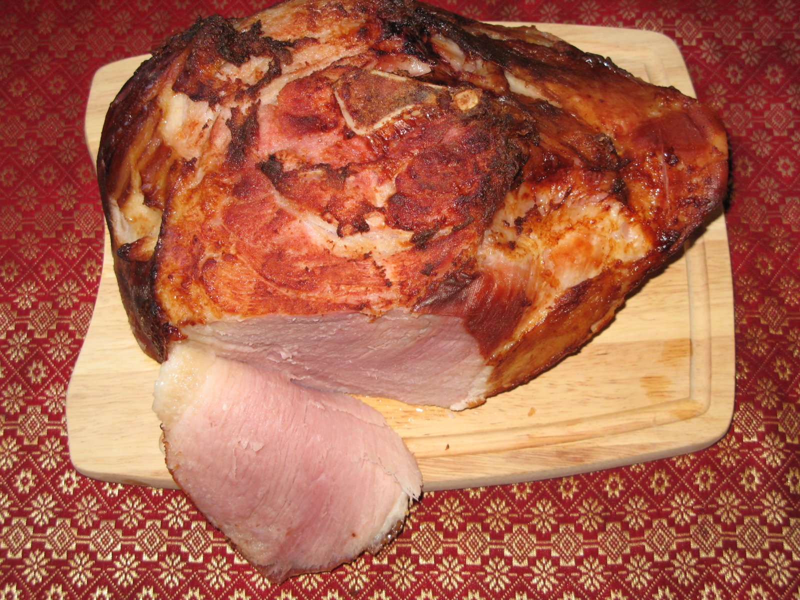 two hams on a  board with one whole meat