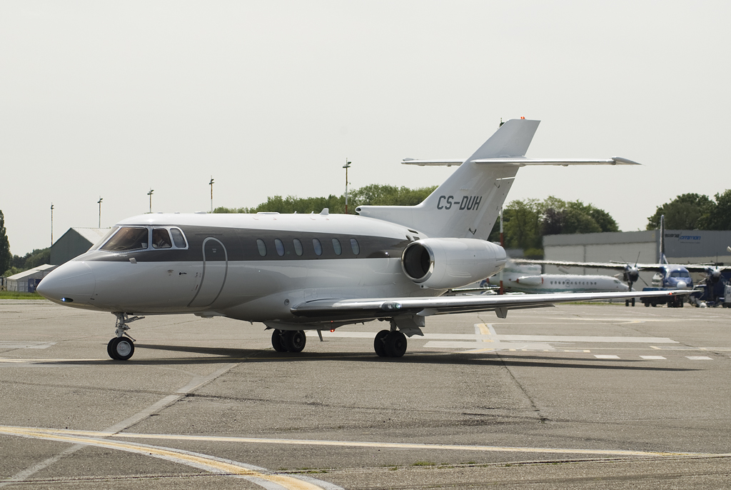 an air craft parked on the tarmac near other planes