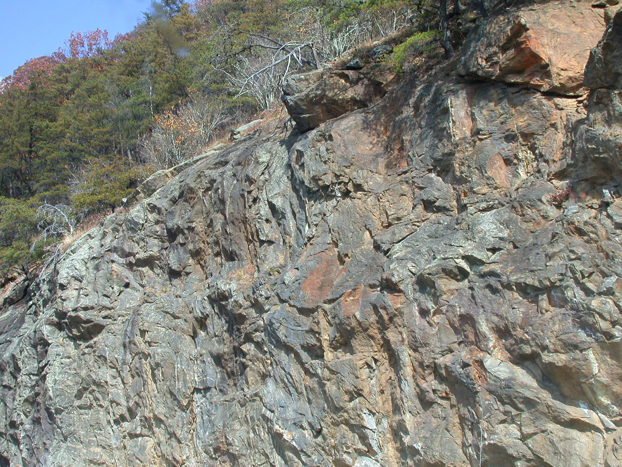 a large rock cliff on the side of the mountain