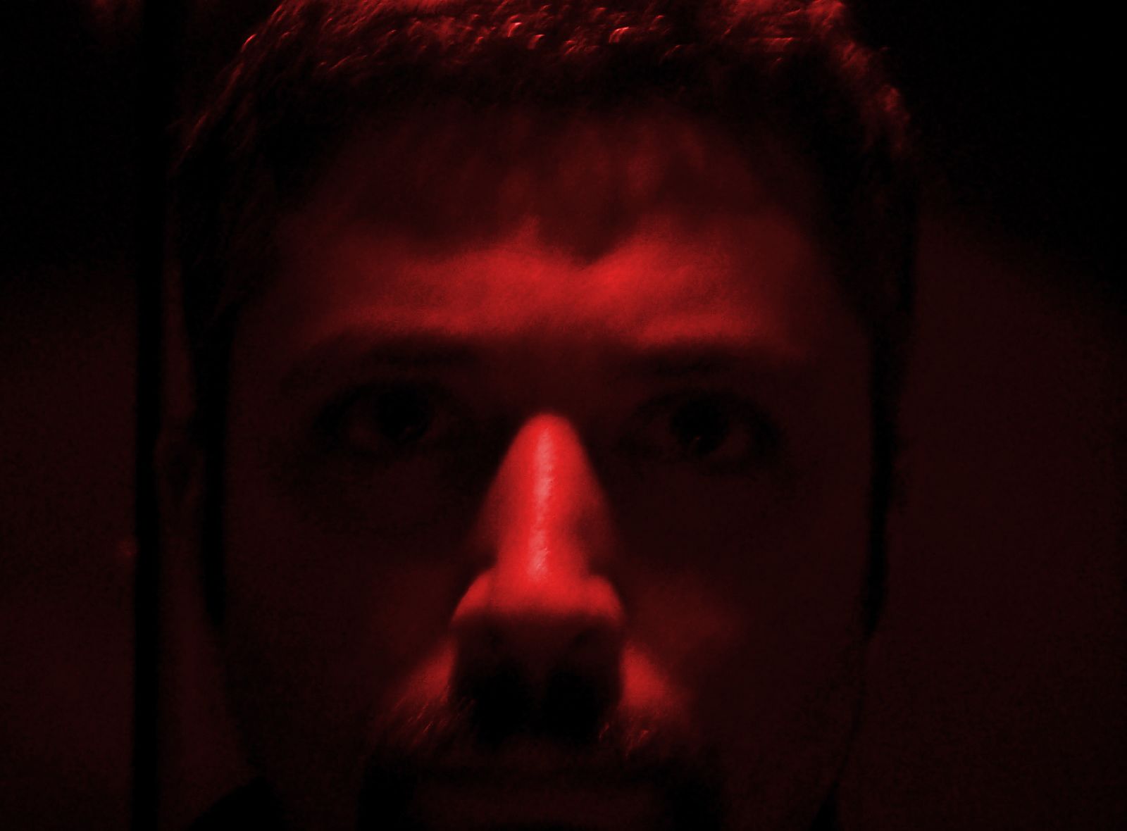 a man making an ugly face in a dark room