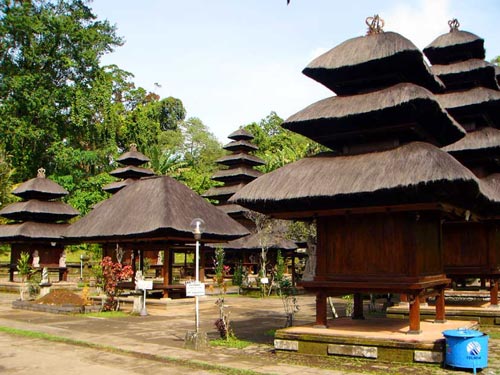 rows of straw roofed wooden structures on cement walkways