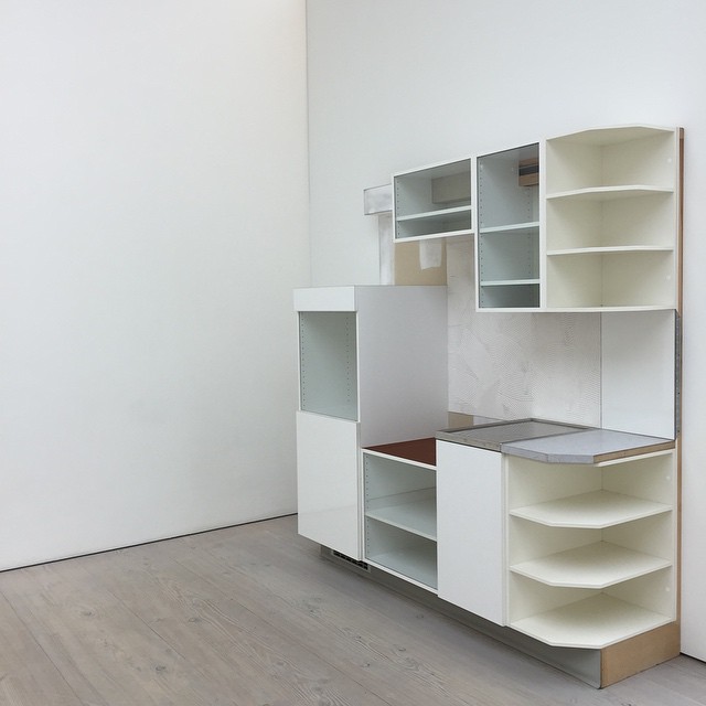 a large white shelves in a room filled with furniture