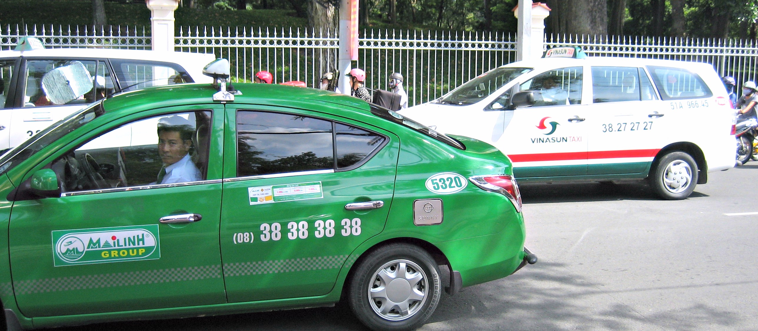 the taxi has a large sign on it's side