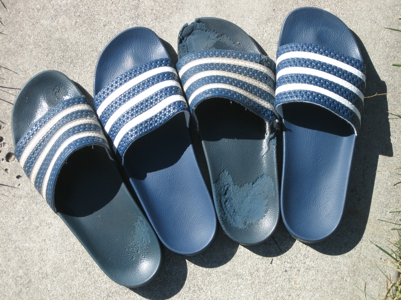 four pairs of shoes lined up on concrete