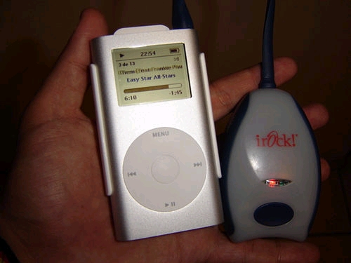 a hand holding an ipod and a mp3 player